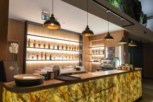 a bar at a restaurant with lights on the wall at Hotel Restaurant Splendor in Buşteni