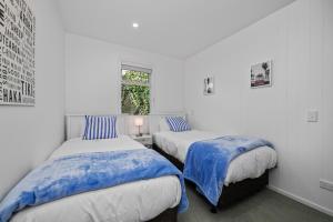 a bedroom with two beds and a window at Sea-Renity Picton, Apt B in Picton