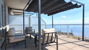 a balcony with chairs and a view of the ocean at Residentie De Zeester | 4 Pers. De Zeester in Scherpenisse