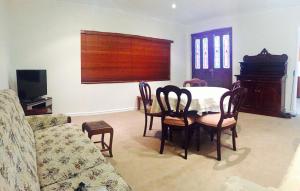 a living room with a table and chairs and a couch at Northlodge Central City Apartments in Perth