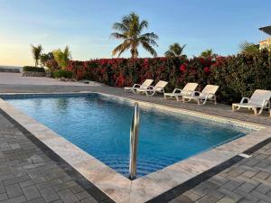 a swimming pool with lounge chairs and a fountain at Apartement Punta Azul 6B, Punta Azul Ocean Resort, Westpunt in Westpunt