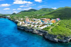 an aerial view of a resort on a rocky island in the ocean at Apartement Punta Azul 6B, Punta Azul Ocean Resort, Westpunt in Westpunt