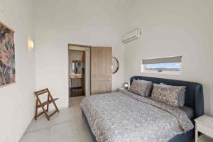 a bedroom with a bed and a chair in it at Apartement Punta Azul 6B, Punta Azul Ocean Resort, Westpunt in Westpunt +29 photos
