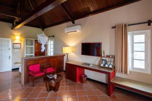 a living room with a desk and a tv at Victoria Nui Sam Lodge in Chau Doc