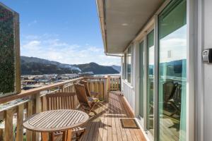 a balcony with a table and chairs and a view at Sea-Renity Picton, Apt B in Picton