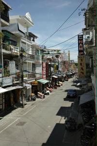 a city street with buildings and a street with cars at Lê Gia Homestay 2 in Hue