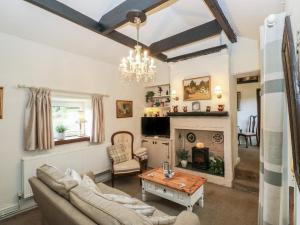 a living room with a couch and a fireplace at Prospect Cottage in Sowerby Bridge