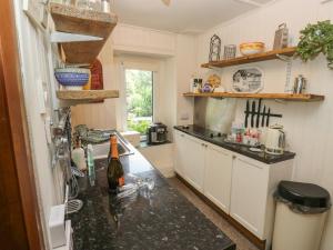 a kitchen with a black counter top in a room at Prospect Cottage in Sowerby Bridge +34 photos