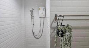 a shower with a hose attached to a wall at Charming Home Resort in Suan Phung +89 photos