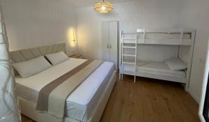 a small bedroom with a bed and a book shelf at Lake Breeze in Gjokaj