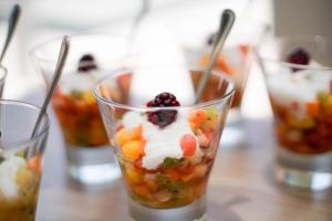 a row of cups filled with fruit and whipped cream at Novotel RJ Porto Atlantico in Rio de Janeiro