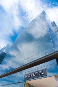 a glass building with a novoiced sign on it at Novotel RJ Porto Atlantico in Rio de Janeiro
