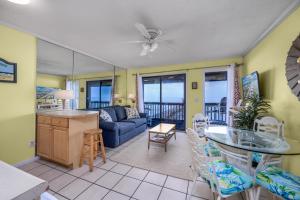 a living room with a couch and a table at Oceanfront 1BR • Top-Floor Balcony Views • Cherry Grove • Sea Cabin 304-A in Myrtle Beach +16 photos