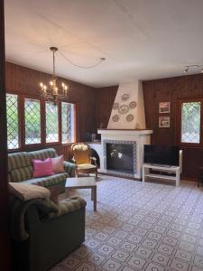 a living room with a couch and a fireplace at Al Mare Home in Pula