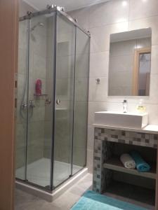 a bathroom with a shower and a sink at Superior Savvas Apartments by the sea in Agia Pelagia