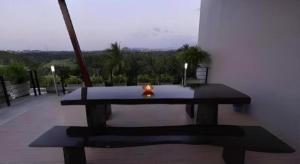 a table with a candle on top of a balcony at Sixty-Sixplace in Ban Khok Lo