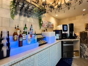 a bar with bottles of alcohol on a counter at Hotel BaliBali 仙台 in Kōtōdaitōri