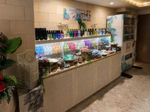 a display case in a store with flowers and plants at Hotel BaliBali 仙台 in Kōtōdaitōri +23 photos