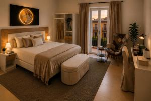 a bedroom with a large bed and a living room at Syraka Design Rooms & Suites in Syracuse