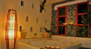 a large bathroom with a tub and a window at Oopkaew Resort in Pua