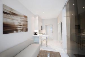 a white room with a white table and a picture at VISIONAPARTMENTS Gerechtigkeitsgasse - self check-in in Zurich