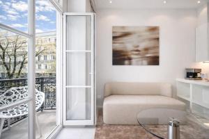 a living room with a couch and a balcony at VISIONAPARTMENTS Gerechtigkeitsgasse - self check-in in Zurich