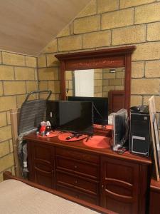 a desk with a computer on it with a mirror at Lavanda City in Sevan