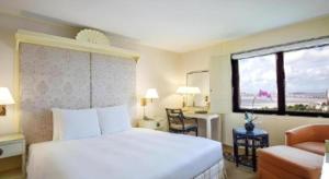 a hotel room with a bed and a window at Regency Art Hotel in Macau +204 photos
