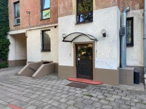 a building with a door and boxes in front of it at Family or Group Apartment in Silent Center in Riga