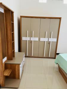 a room with a closet withjar doors in it at MTR Guesthouse in Jaffna
