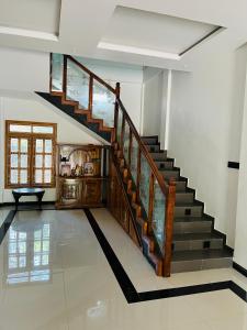 a staircase in a living room with a stair case at MTR Guesthouse in Jaffna