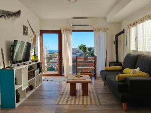 a living room with a couch and a table at Cabaña del Mirador 5 in Puerto Pirámides
