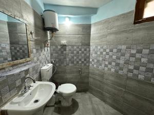 a bathroom with a toilet and a sink at Hill Ice Guesthouse & Cafe - Mountain View & Balcony, Tosh in Tosh +24 photos