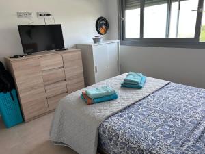 a bedroom with a bed and a tv on a dresser at Nuestro Sueño in Orihuela Costa +15 photos
