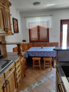a kitchen with a blue table in the middle at Apartma Jurjovka in Nazarje +11 photos
