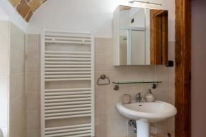 a bathroom with a sink and a mirror at La Rusacca Pacentro in Pacentro +25 photos