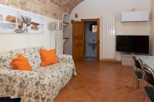 a living room with a couch and a flat screen tv at La Rusacca Pacentro in Pacentro