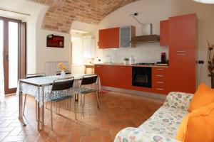 a kitchen and living room with a table and chairs at La Rusacca Pacentro in Pacentro
