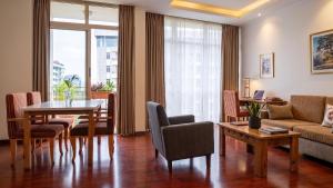 a living room with a table and a couch at Victoria Hotel Apartment in Addis Ababa