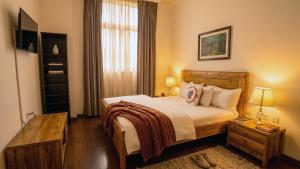 a hotel room with a bed and a window at Victoria Hotel Apartment in Addis Ababa
