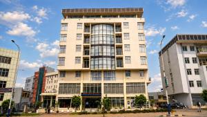 a tall building in the middle of a city at Victoria Hotel Apartment in Addis Ababa