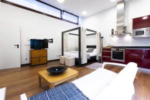 a living room with a couch and a tv at Loft by Basquelidays in Hondarribia