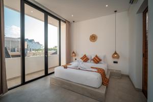 a bedroom with a bed and a large window at Snuggy Shack Villas in Munggu +89 photos