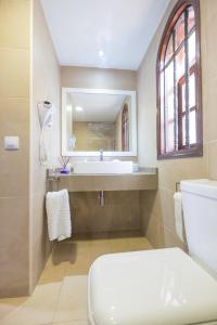 a bathroom with a white toilet and a sink at Sunny Bungalow Parque Golf in Maspalomas