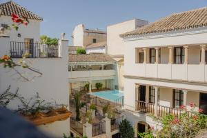a view of two buildings with a swimming pool at Las Casas de la Judería de Córdoba in Córdoba