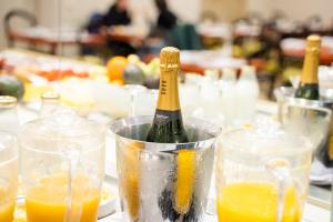a bottle of champagne in a bucket of glasses at Las Casas de la Judería de Córdoba in Córdoba
