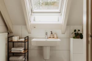 a bathroom with a sink and a window at B&B Mollenvlied Veluwe in Vaassen +42 photos