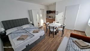 a bedroom with a bed and a table and chairs at Lenkev Living Aparts, Free Parking! in Vienna