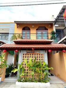 a house with a balcony on the side of it at An Bang Chic Villa Nguyên Căn in Tân Thành (1)