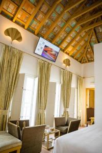 a hotel room with a bed and a tv on the ceiling at Las Casas de la Judería de Córdoba in Córdoba